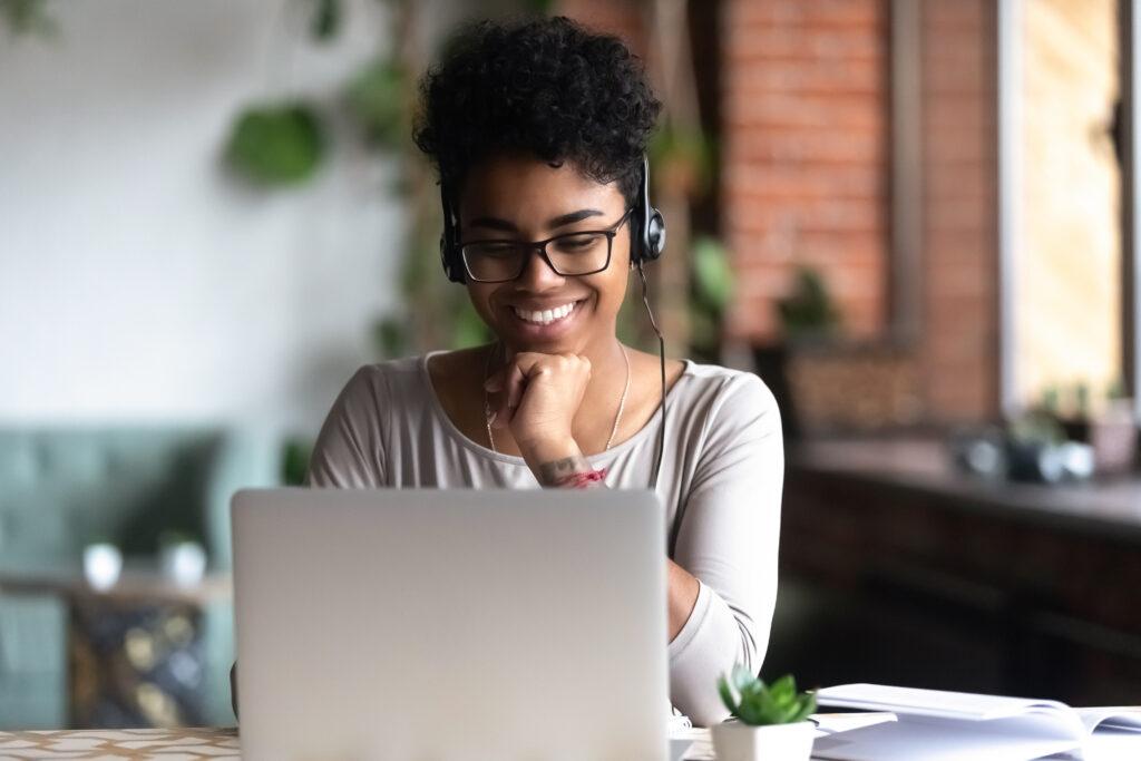 A young woman studying using a laptop.