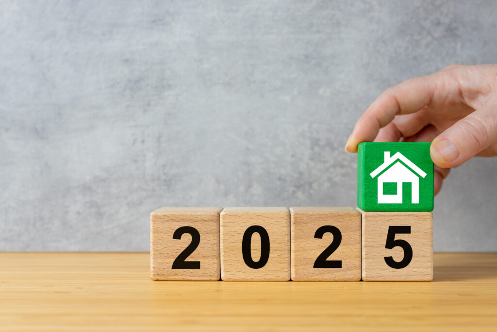 A green wooden block with a house on top of four wooden blocks saying 2025.